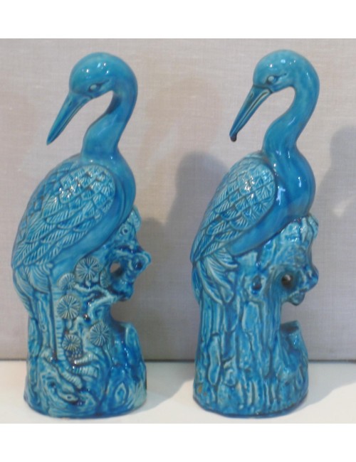 Coppia di sculture in ceramica smaltata , rappresentanti aironi posati su basi naturalistiche.