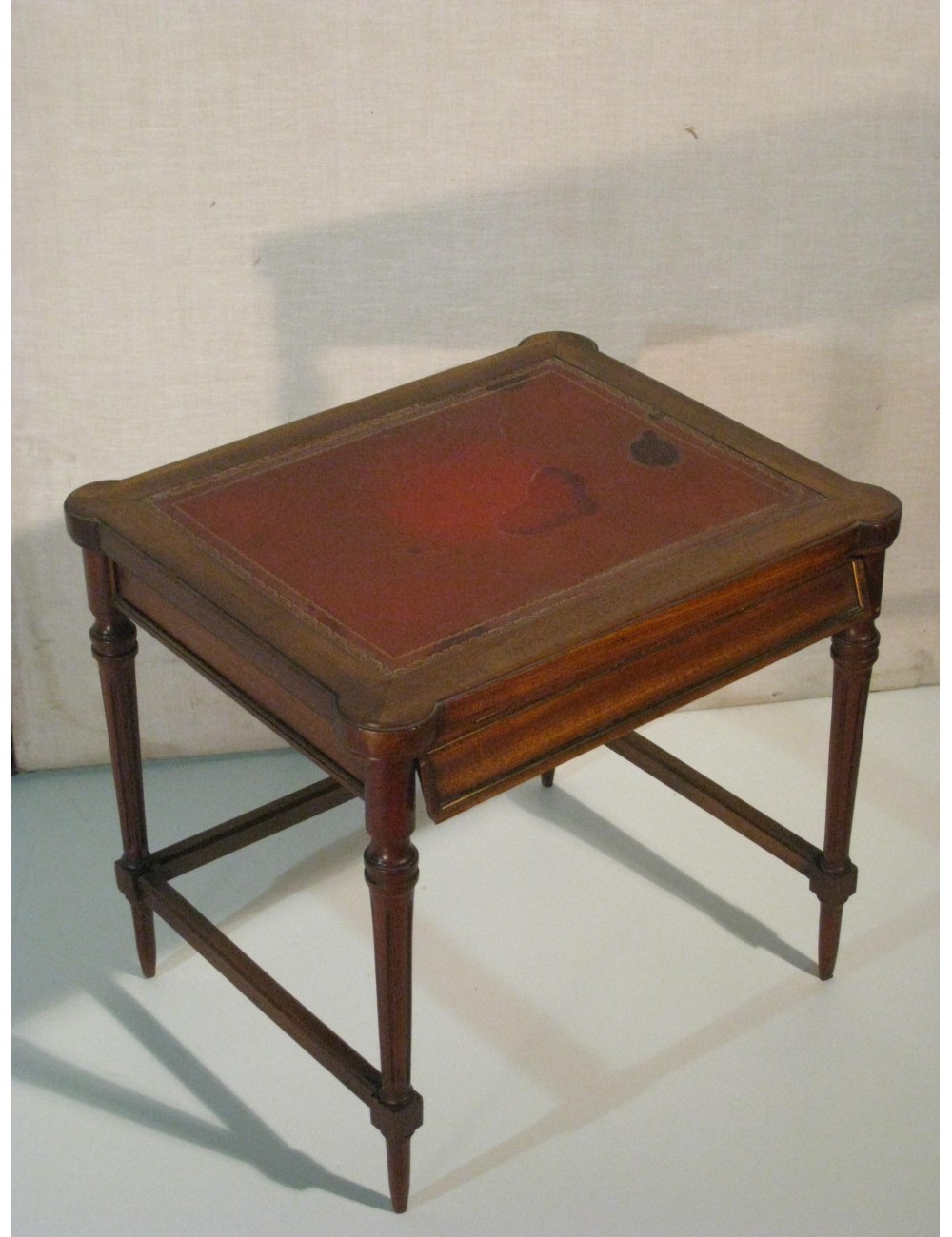 Square coffee table with red leather top Square coffee table with red leather top