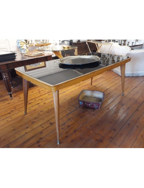 Tavolo rettangolare, piano in cristallo nero e puntali in ottone
